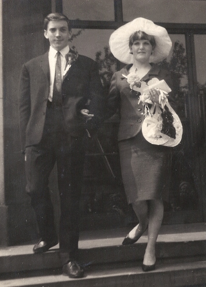 Black and white photo of Nan and Grandad walking down the steps outside.